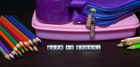 School pencils and lunchbox for back to school concept on table in group