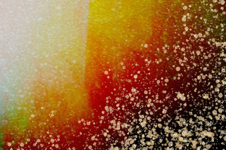 Rising red and yellow inks with gold drops at the bottom. Alcohol ink fluid abstract texture fluid...