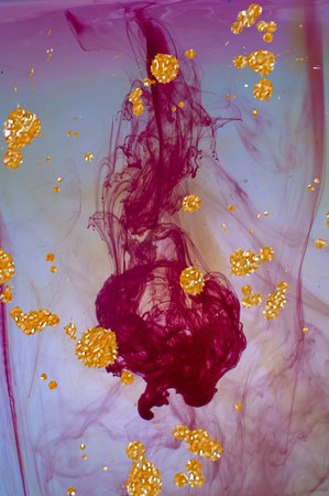Red ink dropping in water. Alcohol ink fluid abstract texture fluid art with gold glitter and liquid with shades.の写真素材