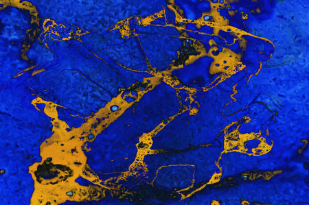 Golden dust and areas of gold on blue Alcohol ink fluid abstract texture fluid art with gold glitter...