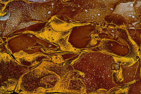 Dark orange color with small drops and golden dust on Alcohol ink fluid abstract texture fluid art...