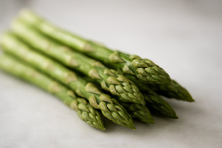 Fresh green asparagus on white marble table, shallow depth of fieldの素材