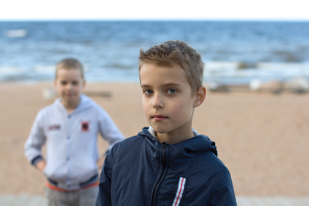 Boys-teenagers, brothers, schoolboys. Summer vacation on the beach.の写真素材