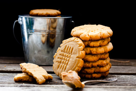 shortbread cookie with peanut butter on a black background