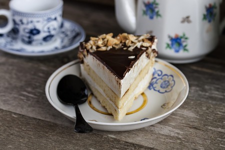 Cake bird's milk with chocolate and coconut on wooden backgroundの写真素材