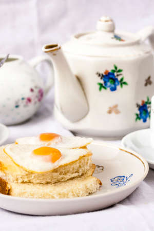 Breakfast with croissants, quail eggs and teaの写真素材