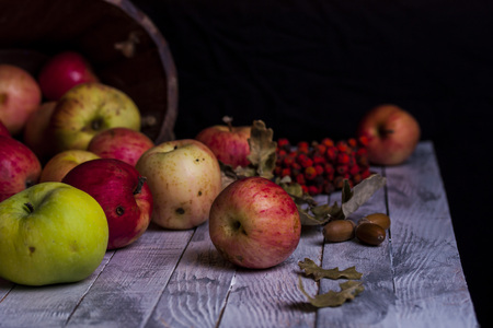 Apples fell from the basket on the tableの写真素材