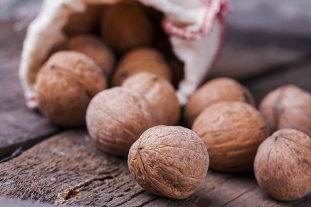 scattered walnuts the shell on a wooden backgroundの写真素材