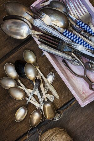 Old fork and spoon on wooden backgroundの写真素材