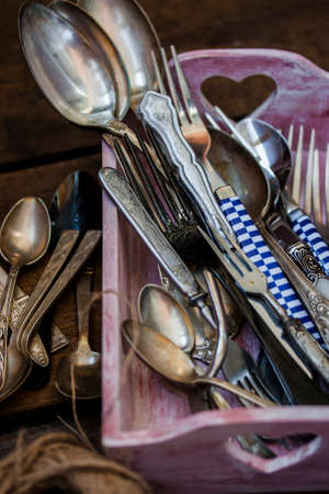 Old fork and spoon on wooden backgroundの写真素材
