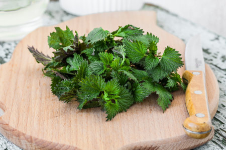 stinging young nettle on a cutting board