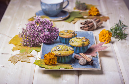 Homemade pumpkin muffins on the wooden tableの写真素材