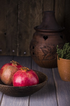 fresh juicy pomegranate on a dark wooden backgroundの写真素材