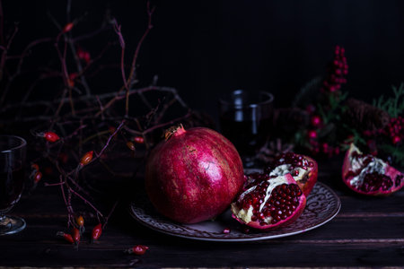 pomegranate and pomegranate juice on a dark backgroundの写真素材
