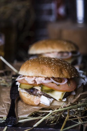 Fresh homemade burger closeup on wooden tableの写真素材