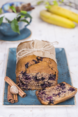 banana bread with blueberries and cinnamon on bright backgroundの写真素材