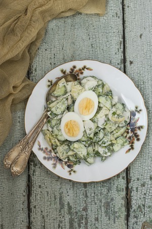 spring potato salad with egg,radishes and cucumbersの写真素材