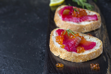 appetizer ciabatta with beet Gravlax salmon with caviarの写真素材