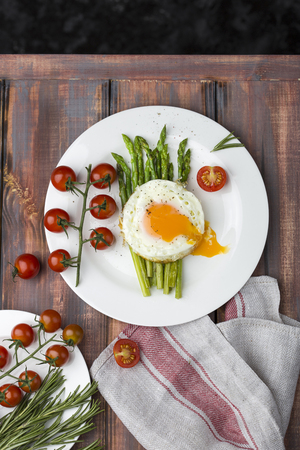 green asparagus with fried eggsの写真素材