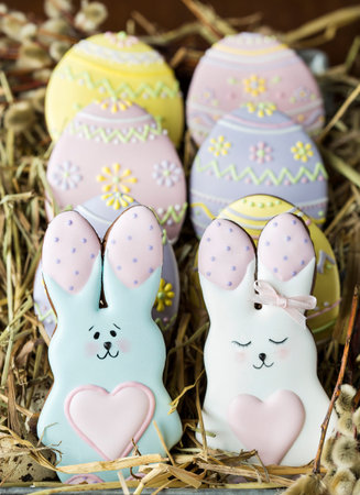 homemade colorful glazed Easter cookies on dark table