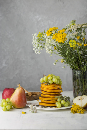 stack of pumpkin pancakes with cinnamon and honeyの写真素材