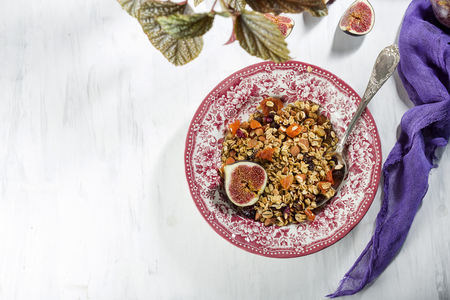 homemade granola with figs in a vintage plateの写真素材