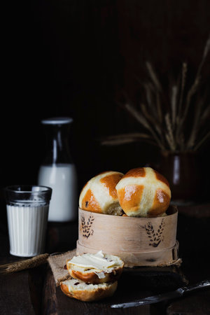 classic English Easter hot cross buns with dried fruits on vintage background