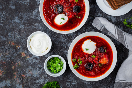Traditional Ukrainian Russian borscht with prunes and sour cream