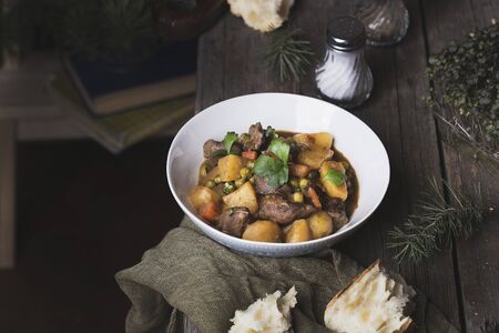 traditional irish beef and  beer stew with carrots, potatoes and green peasの写真素材