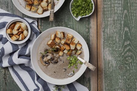 Creme soup with mushrooms and croutons in white bowlの写真素材