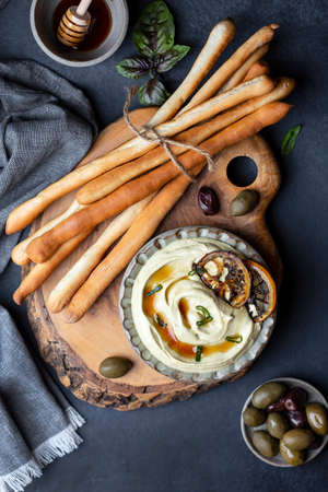italian breadsticks grissini with feta cheese dipの写真素材