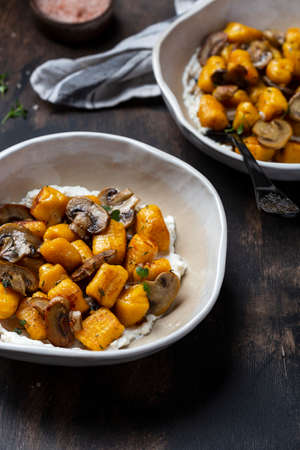homemade pasta pumpkin gnocchi with mushroom sauce and ricottaの写真素材