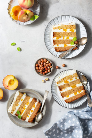 slices of peach cake with buttercream and honey on a light background