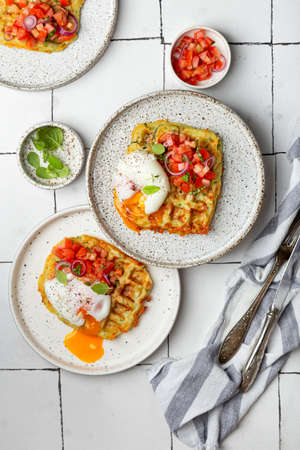homemade zucchini waffles with tomato tartare and poached eggの写真素材