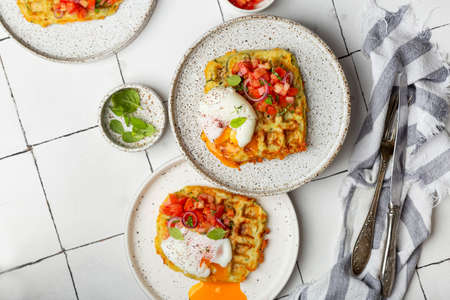 zucchini waffles with tomato tartare and poached eggの写真素材