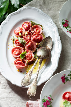 Beetroot ravioli with goat cheese, mozzarella, parmesan, butter sauceの写真素材