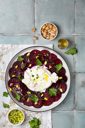 Beetroot carpaccio with mozzarella burrata and pistachiosの写真素材