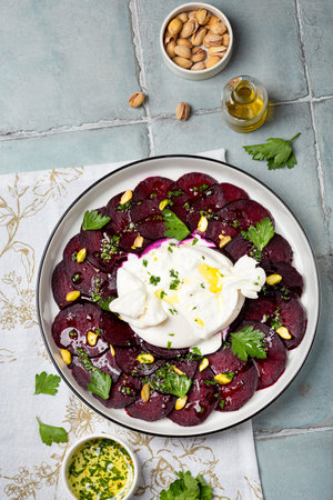 Beetroot carpaccio with mozzarella burrata and pistachiosの写真素材