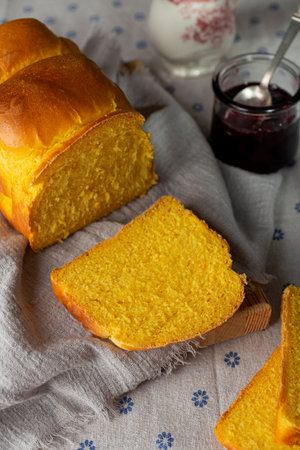 homemade yeast wheat carrot bread with butter and jamの写真素材