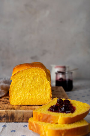 homemade yeast wheat carrot bread with butter and jamの写真素材