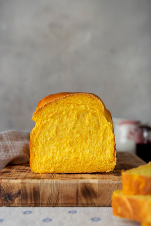 homemade yeast wheat carrot bread with butter and jamの写真素材