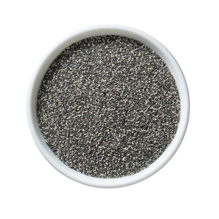 A white ceramic bowl is filled to the brim with small, dark chia seeds. The seeds are tiny and round, with a speckled black and grey appearance. They are viewed from directly above, creating a uniform texture within the circular bowl. The bowl itself is simple and white, with a subtle rim. The entire image is set against a stark black background, emphasizing the contents of the bowl.の素材