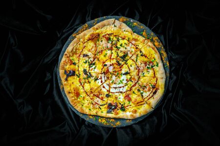 Tasty pizza on black background. Top view of hot pizza.の写真素材