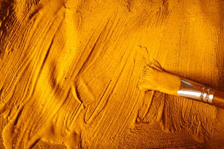 A beautiful Gold paint texture on wall, background - Image. Color paint strokes.の写真素材