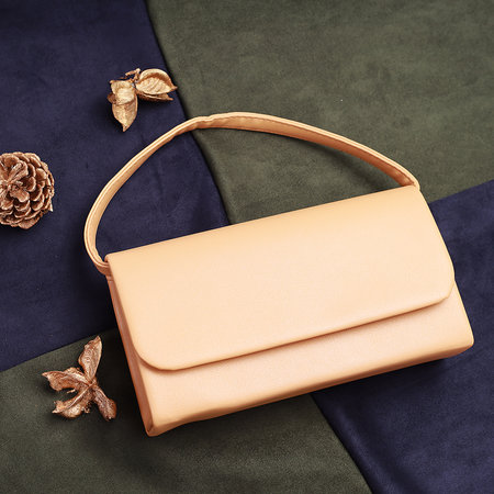 Yelloy women's clutch with a chain on a green and blue background top viewの写真素材