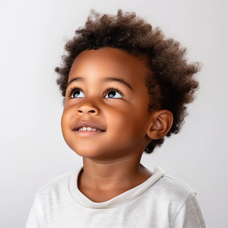 portrait of a cute smiling African American boy wearing a shirt. on a white backgroundの素材