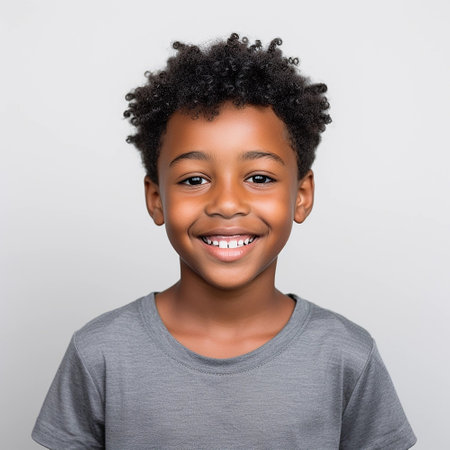 portrait of a cute smiling African American boy wearing a shirt. on a white backgroundの素材