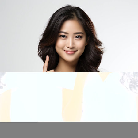 Asian woman with long, flowing hair poses against a neutral background. her elegant smile and casual white shirt suggest themes of fashion, confidence, and modern lifestyle, Asian beauty and elegance.の素材