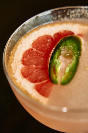 A refreshing grapefruit jalapeÃ±o mocktail served in a glass, combining tangy citrus with a spicy...