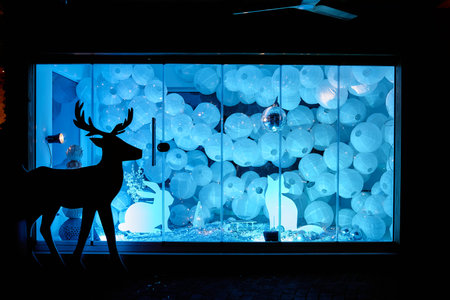 A mesmerizing winter scene showcasing a deer silhouette against a striking backdrop of blue-lit orbs...